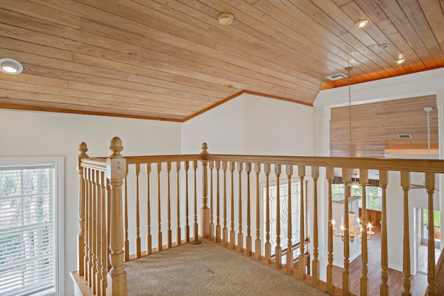 hall featuring an inviting chandelier, lofted ceiling, wood ceiling, and carpet flooring