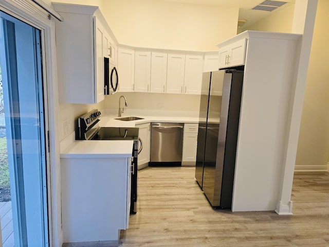 kitchen featuring sink, white cabinetry, white appliances, and decorative backsplash