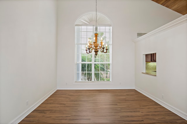 unfurnished dining area featuring high vaulted ceiling, dark hardwood / wood-style flooring, and a notable chandelier