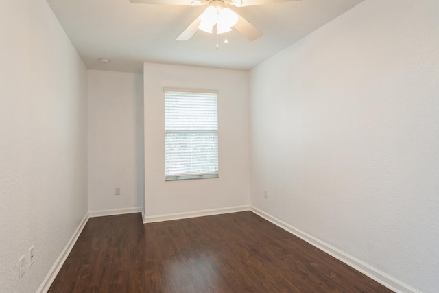 spare room with ceiling fan and dark hardwood / wood-style flooring