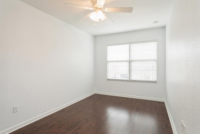 spare room with ceiling fan and dark hardwood / wood-style floors