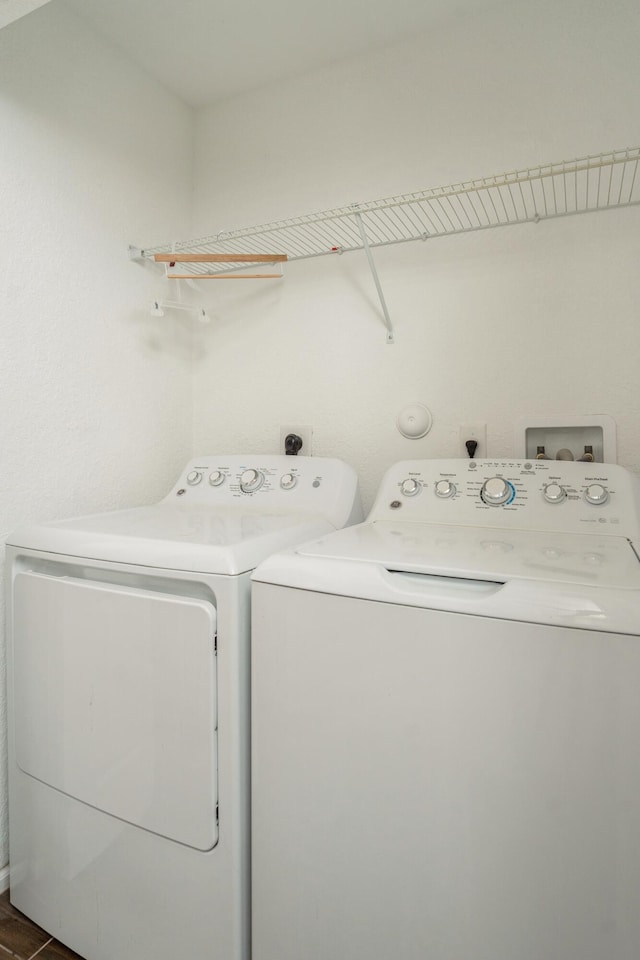 clothes washing area featuring washer and dryer and laundry area