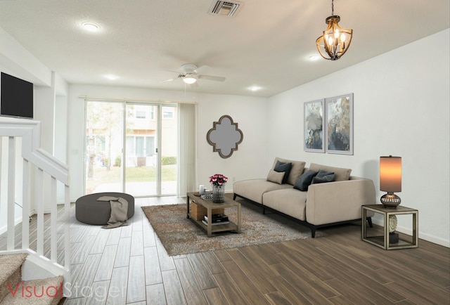 living area featuring visible vents, baseboards, stairs, and wood finish floors