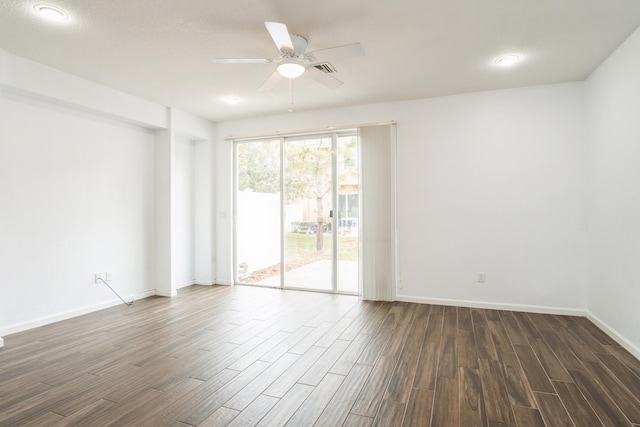 unfurnished room featuring visible vents, a ceiling fan, baseboards, and dark wood-style flooring