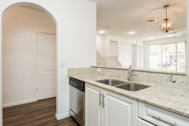 kitchen with stainless steel dishwasher, sink, dark hardwood / wood-style flooring, white cabinetry, and decorative light fixtures