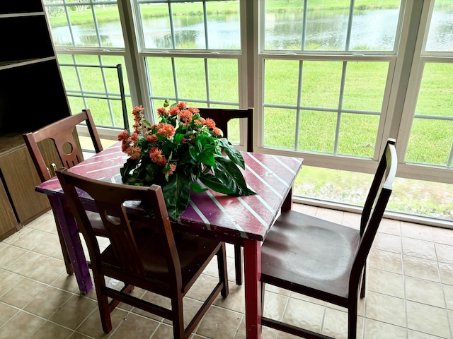 sunroom / solarium featuring a water view and a wealth of natural light