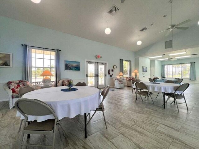 dining room featuring high vaulted ceiling