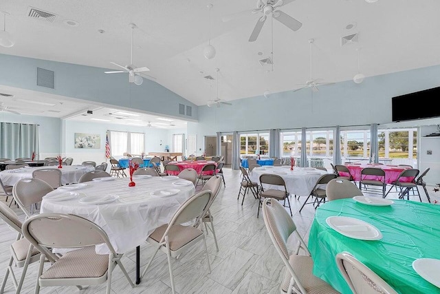 dining space featuring high vaulted ceiling, visible vents, and a ceiling fan