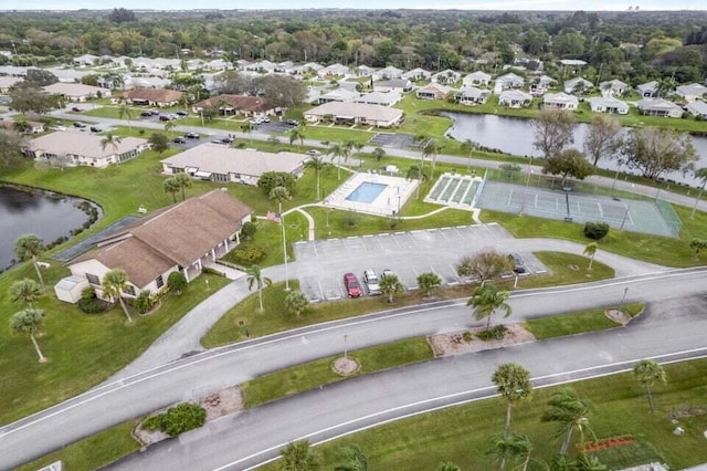 drone / aerial view featuring a water view and a residential view