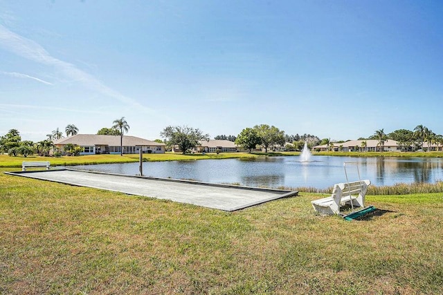 exterior space with a water view and a lawn