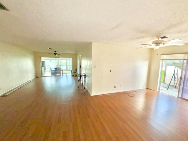 empty room featuring ceiling fan, light hardwood / wood-style floors, and a textured ceiling