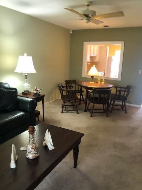 living room featuring carpet and ceiling fan