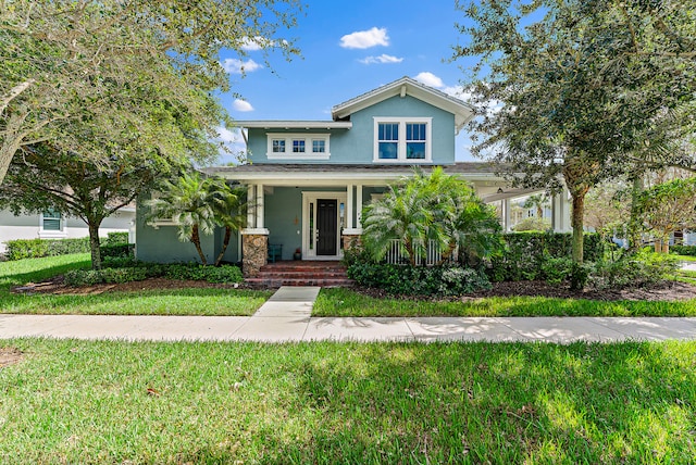 view of front of home featuring covered porch and a front yard