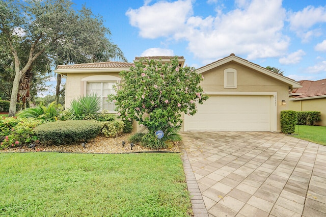 view of front of property with a front lawn and a garage