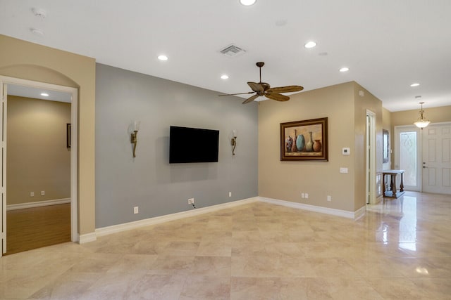 unfurnished living room with ceiling fan