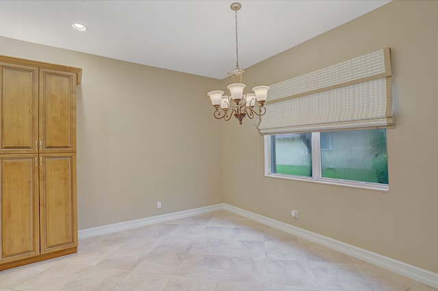 unfurnished room with an inviting chandelier