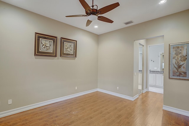 empty room featuring light wood-type flooring and ceiling fan