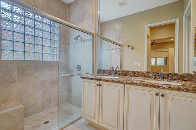 bathroom featuring vanity and a shower with shower door