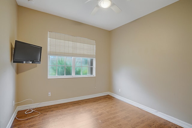 empty room featuring hardwood / wood-style flooring and ceiling fan