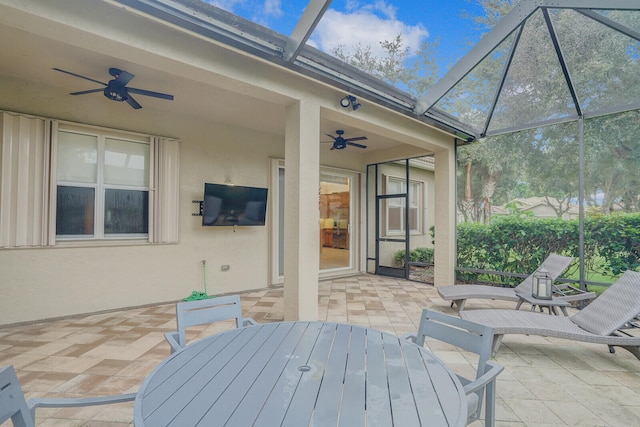 view of patio / terrace featuring glass enclosure and ceiling fan