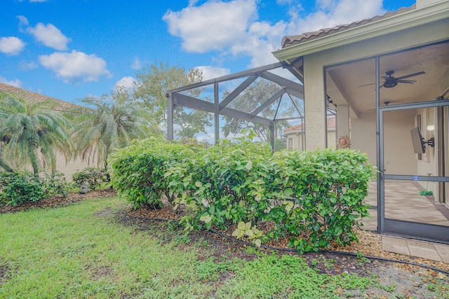 exterior space featuring a lanai, ceiling fan, and a patio area