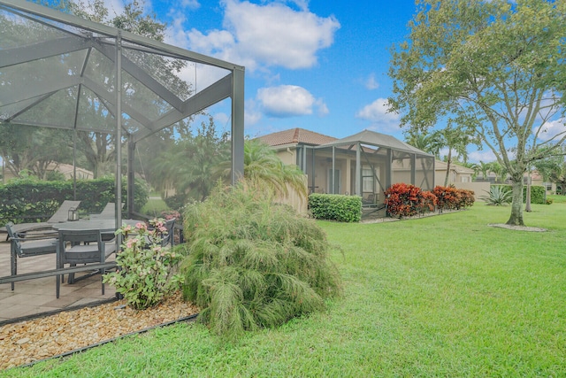 view of yard with a lanai and a patio