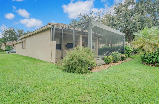 view of property exterior with glass enclosure and a lawn