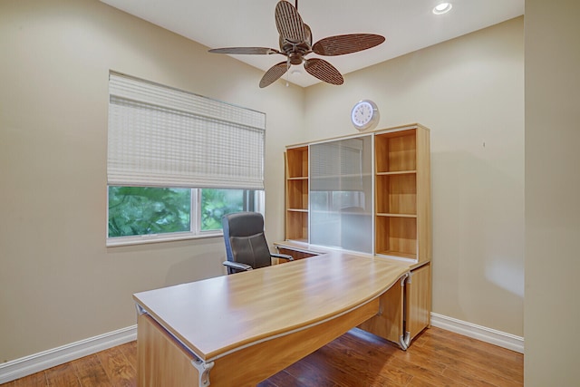 home office with ceiling fan and light hardwood / wood-style flooring