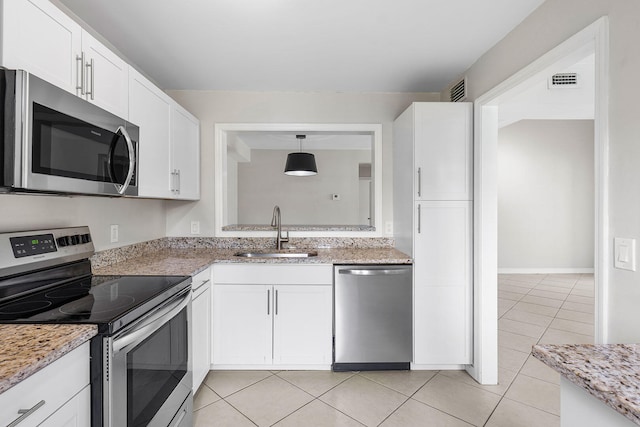 kitchen featuring white cabinets, decorative light fixtures, stainless steel appliances, and sink