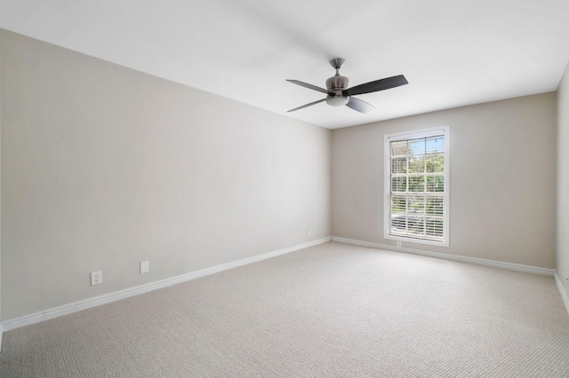 empty room with ceiling fan and carpet