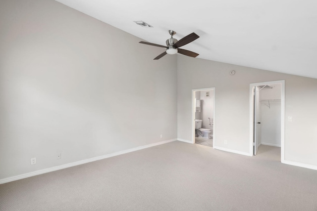 unfurnished bedroom featuring carpet flooring, connected bathroom, a spacious closet, and ceiling fan