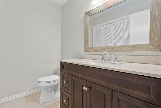 bathroom featuring tile patterned flooring, vanity, and toilet