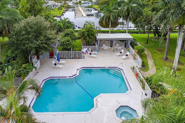 view of swimming pool featuring a water view and a patio area