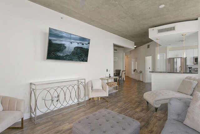 living room with dark wood finished floors and visible vents