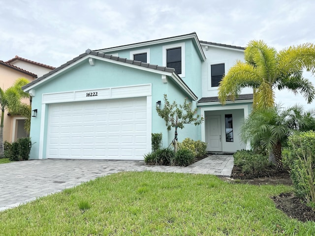 view of front facade with a garage and a front lawn