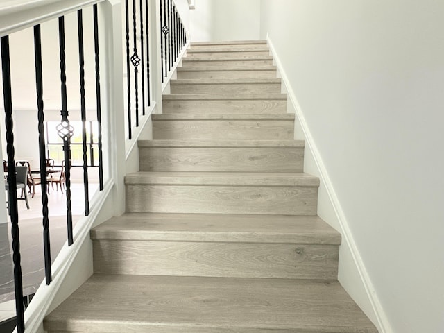 stairs with hardwood / wood-style flooring