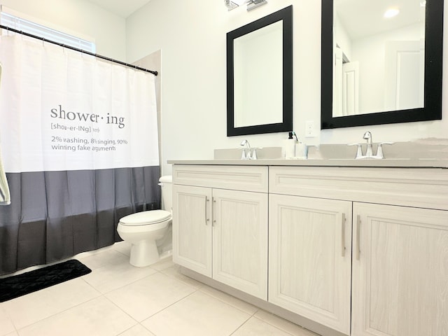 bathroom featuring walk in shower, vanity, toilet, and tile patterned floors