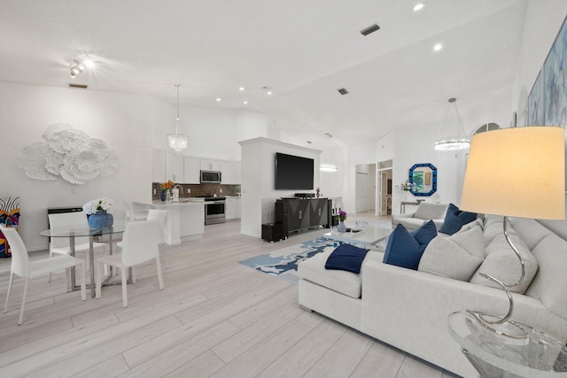 4561 Carlton Golf Dr, Lake Worth, FL 33449 - living room with recessed lighting, light wood-type flooring, and high vaulted ceiling