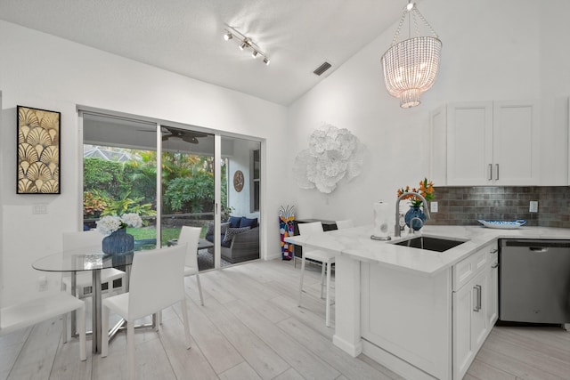 4561 Carlton Golf Dr, Lake Worth, FL 33449 - kitchen featuring a sink, a notable chandelier, lofted ceiling, light stone countertops, and dishwasher