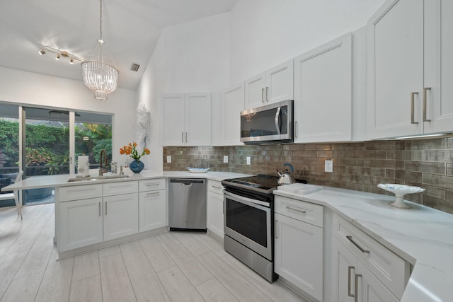 4561 Carlton Golf Dr, Lake Worth, FL 33449 - kitchen with a sink, tasteful backsplash, visible vents, a chandelier, and appliances with stainless steel finishes