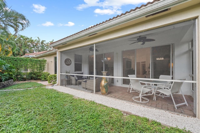 4561 Carlton Golf Dr, Lake Worth, FL 33449 - rear view of property featuring stucco siding, a tiled roof, ceiling fan, and a lawn