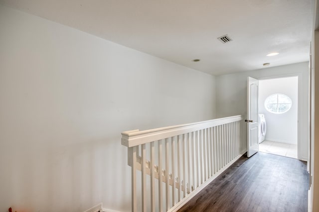 hall with washer / clothes dryer and dark hardwood / wood-style floors