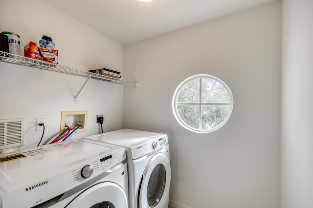 clothes washing area with separate washer and dryer