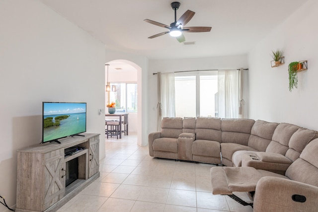 tiled living room with ceiling fan