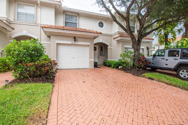 mediterranean / spanish-style home featuring a garage