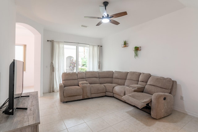 tiled living room with ceiling fan