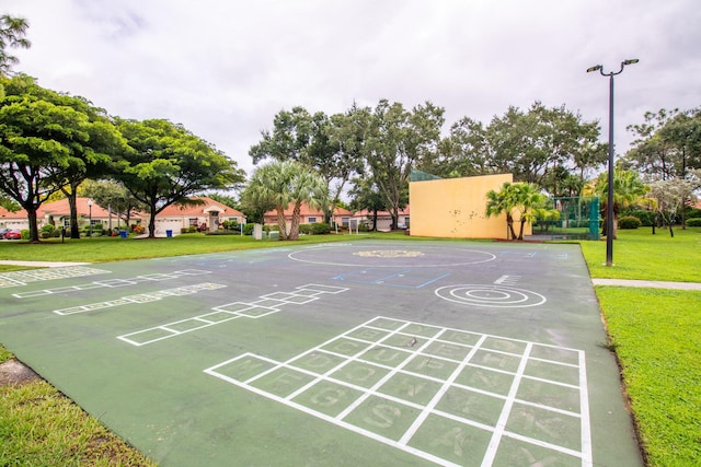 view of home's community featuring a yard and basketball court