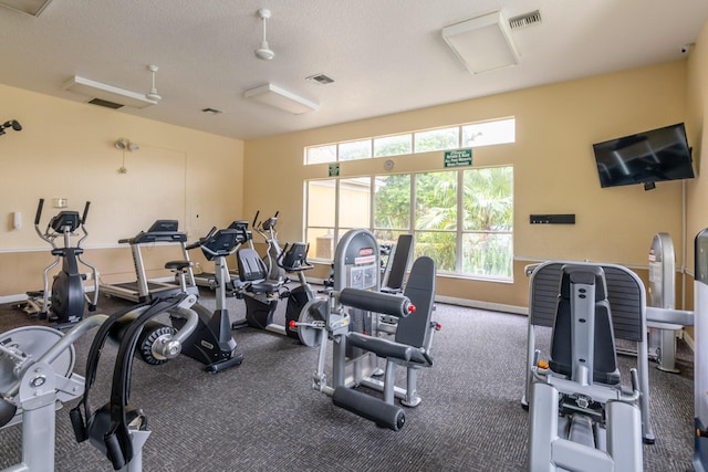 workout area featuring a textured ceiling