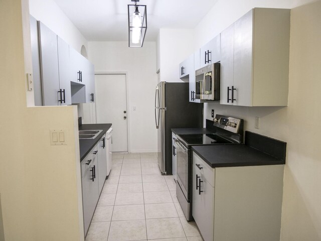 kitchen featuring white cabinets, white dishwasher, stainless steel refrigerator, and sink