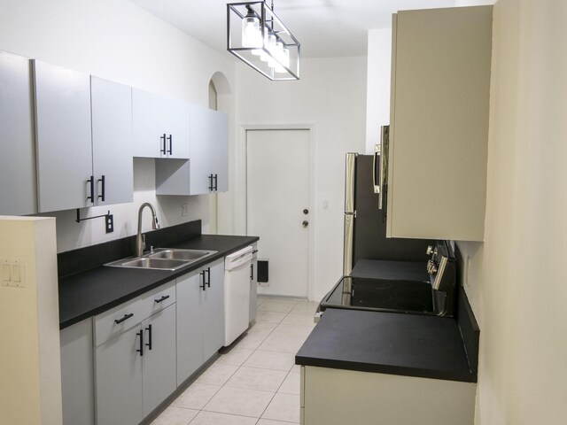 kitchen with white cabinetry, sink, stainless steel appliances, decorative light fixtures, and light tile patterned flooring